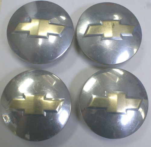 For sale set of four used 3.1&#034; chevrolet polish &amp; gold center caps