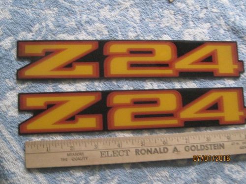 Nos 1980s chevrolet cavalier yellow-orange z/24 stick on emblems-2 pieces