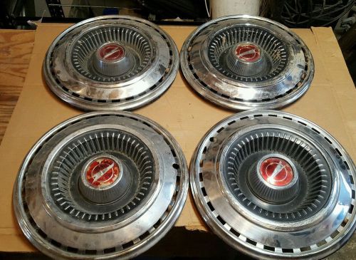 Set of four vintage 14&#034; pontiac?  hub caps used