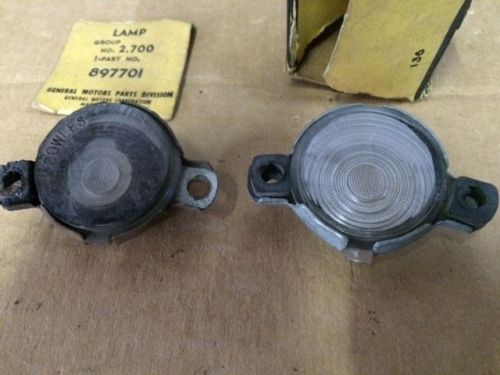 1955-1956 chevy &#034;&#034;&#034;nos&#034;&#034;&#034; gm license plate lamp in box,also 1 used part