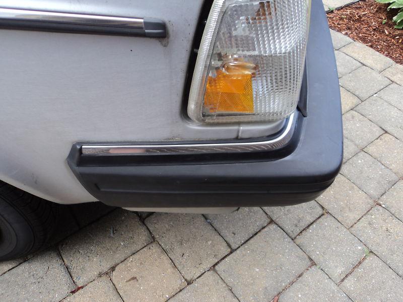 Volvo 240 86-93 right front bumper corner trim "hockey stick" passenger side 