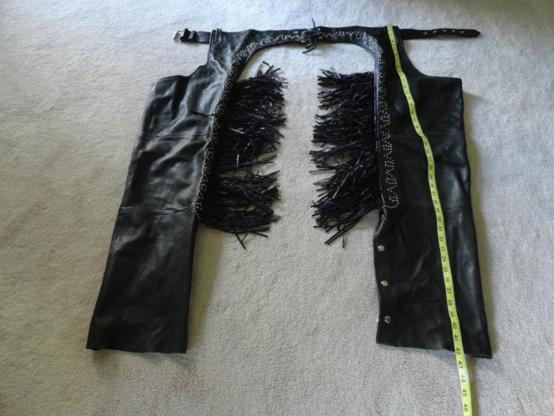 Women's black motorcycle chaps with studs and black and purple fringe
