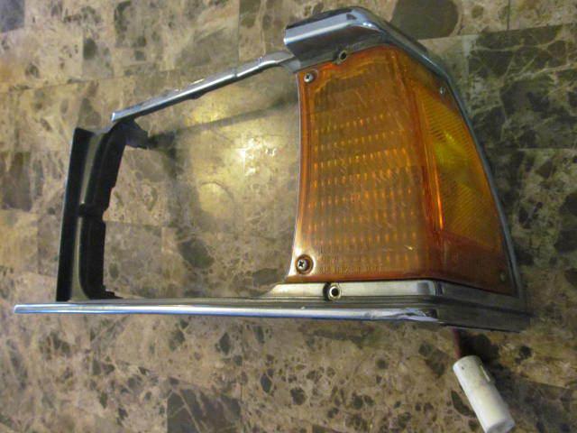 1983 toyota corolla chrome left headlight trim and corner light assembly.