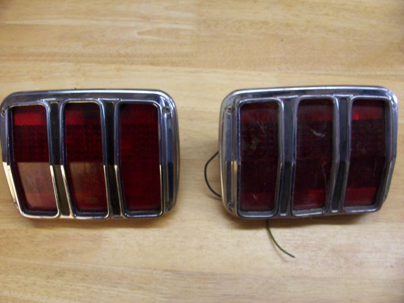 64 65 66 mustang, complete tail light assemblies, one very nice, 1 good housing