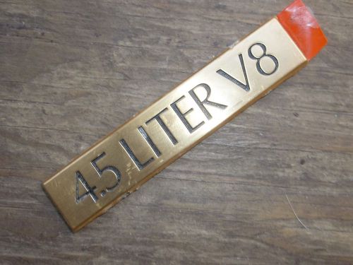 One 1985-1993 cadillac 4.5 litre v8 emblem, factory tape on rear - 3 5/8&#034; long