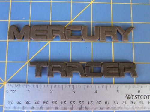 #1039 1987 - 1990 mercury tracer trunk decklid logo emblems (blackout) badges