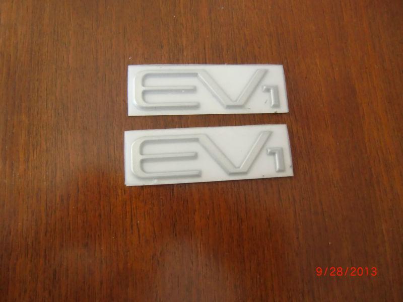 Pair of general motors electric vehicle ev1 emblems