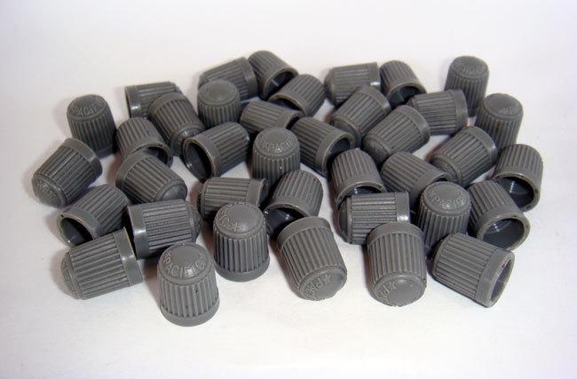 100 pcs. dark gray plastic tire valve stem cap.