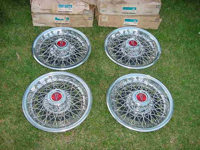 Pontiac nos factory 14" red plastic center wire wheel covers four