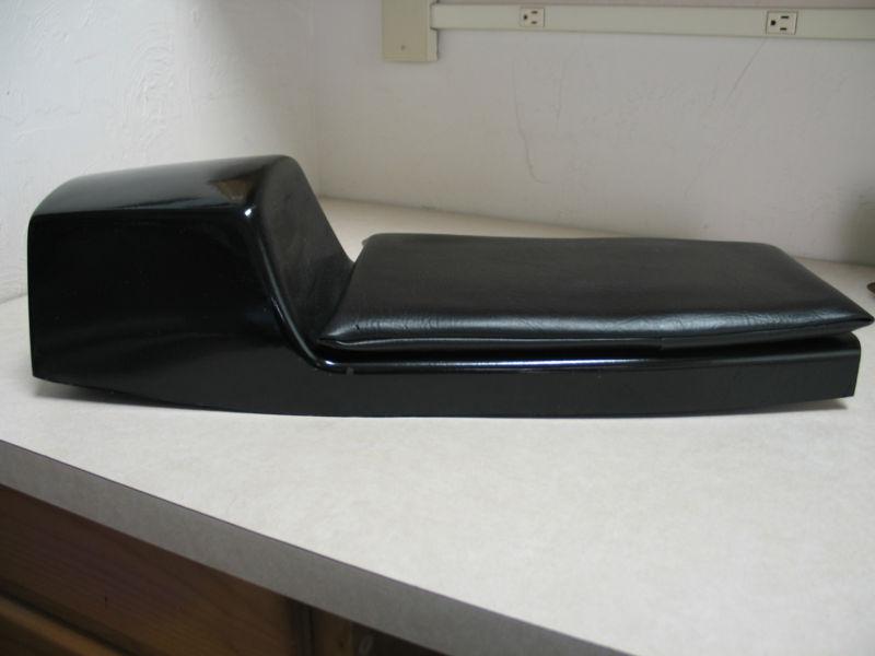Traditional style motorcycle cafe racer fiberglass seat pan with seat pad . 