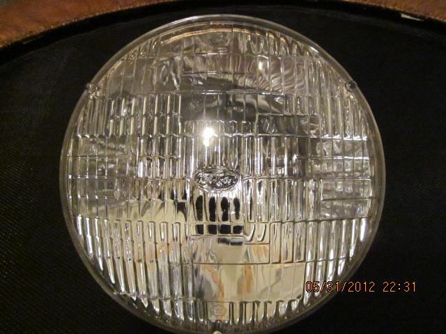 Ford (fomoco) 6 volt sealed beam headlight. has fomoco in ford script  on front