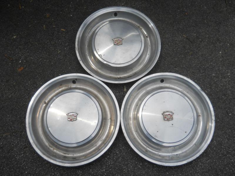 Three   hub caps for vintage cadillac