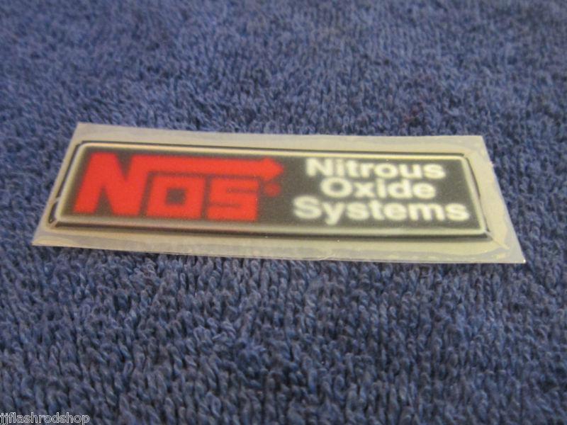 Nos adhesive backed dash emblem, 3/4 x 2 3/4, heavy weight, new