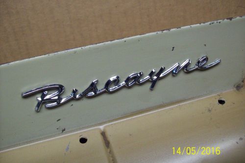 1958 chevy biscayne emblem from glove box door. very nice used original w/ clips