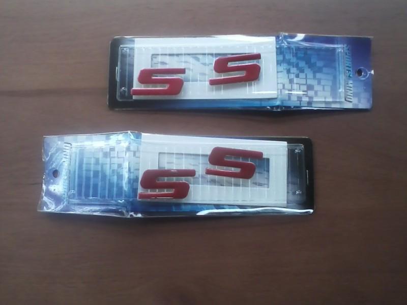 Iridescent red ss emblems, two pair, new
