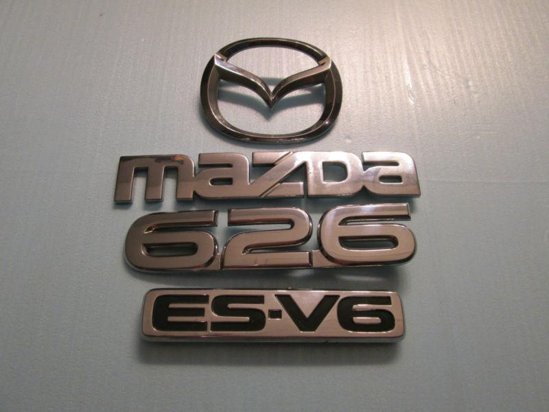 00 01 02 mazda 626 es-v6 rear trunk emblem decal badge logo used oem factory 