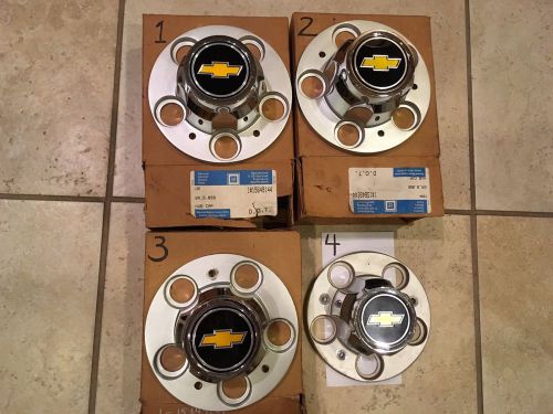 4 chevy rally center caps- 3 new  and 1 used but very good