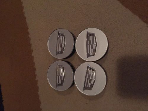 Cadillac wheels center caps.dts sts etc.new condition