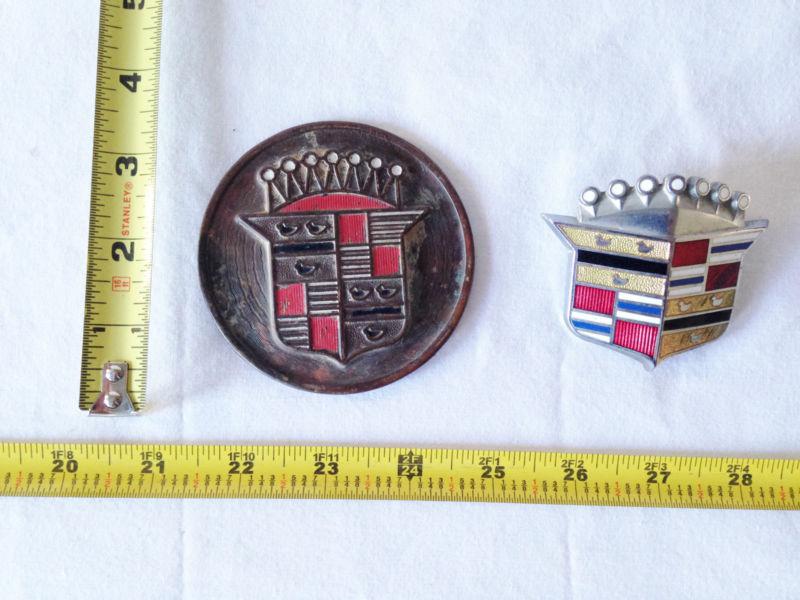 Vintage cadillac hubcap center medallion and one other cadillac emblem