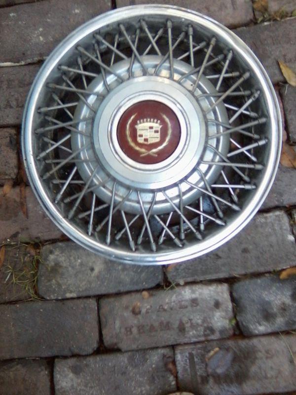2 cadillac  fwd wire wheel covers, burgundy center 15 inch