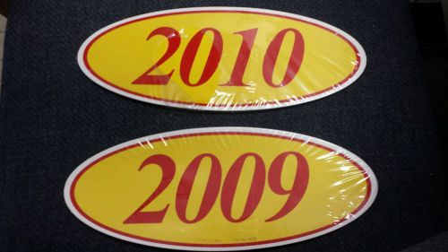 2 dozen yellow and red oval year stickers 1 dozen 2009 and 1 dozen 2010 dealer