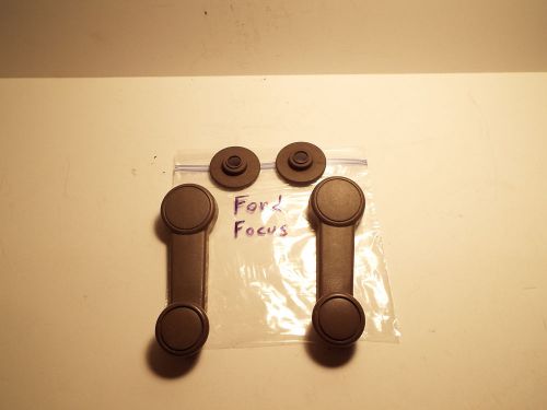 Pair of tan ford focus window crank handles.