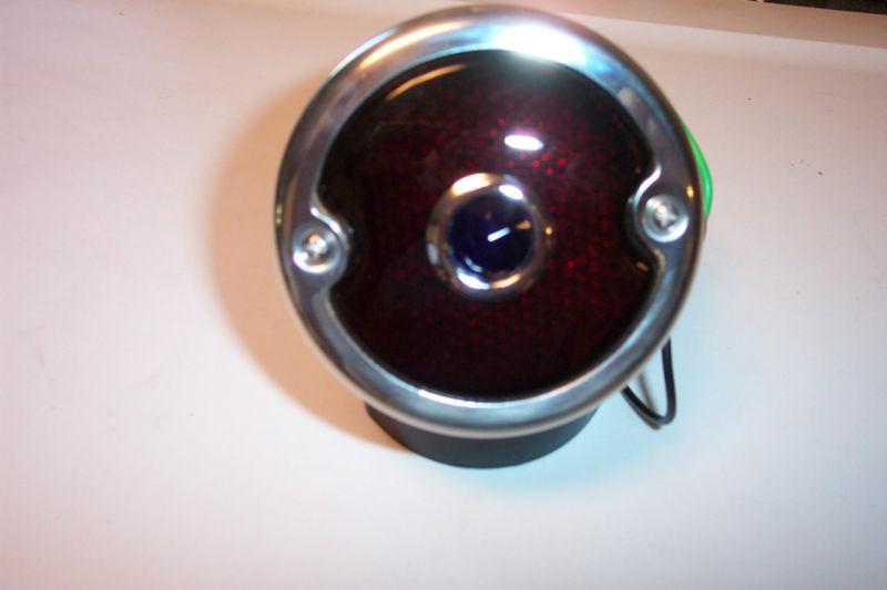 1933-36 ford tail light, black housing, stainless rim and glass lens, new.