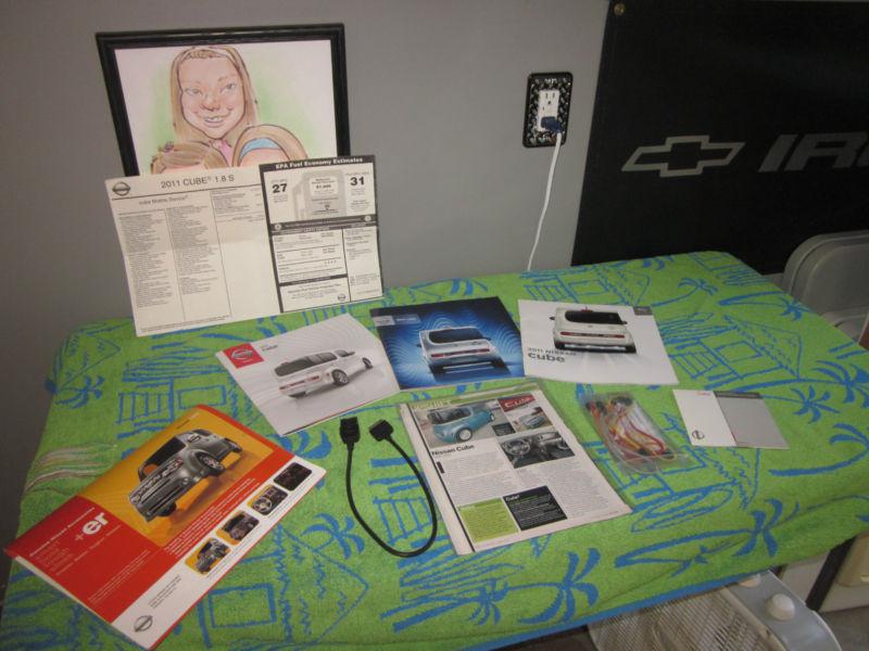 Nissan lot of misc. items: ipod connector, brochures, window sticker, articles