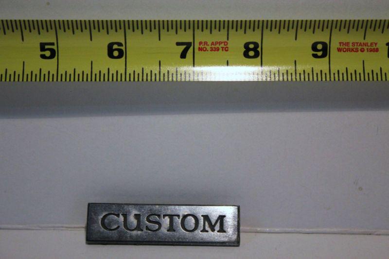 Old car emblem " custom " removed from junked car many years ago