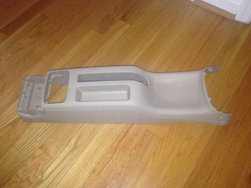 Find USED early style OEM VW beige / tan rear center console for MK4