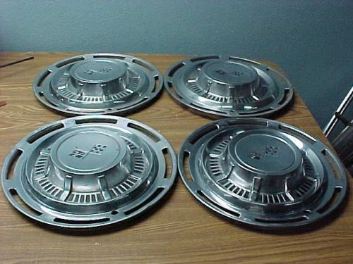Vintage set of 4 chevy cross flag hub caps