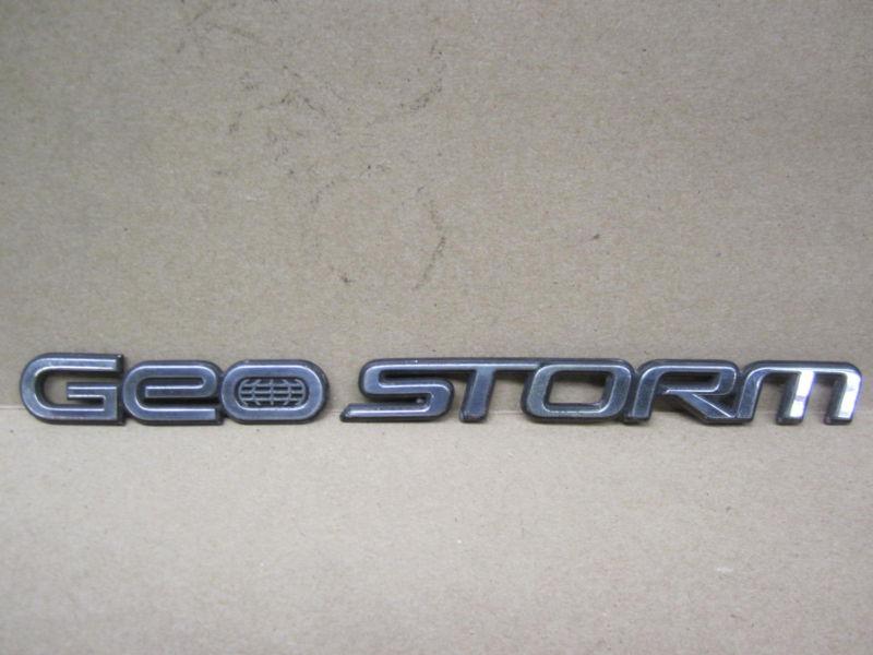 Geo storm emblem ornament " geo storm "  oe plastic / chrome