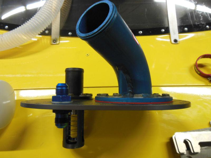 Fuel safe atl filler plate assembly with spring loaded paddle valve