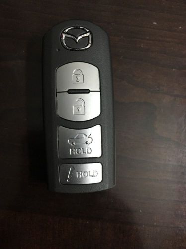 Mazda 4 button smart key fob oem fcc id: wazske13d01 - used - good condition