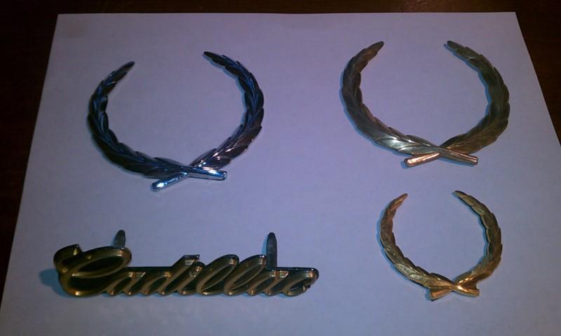 1980's cadillac wreath emblems and gold "cadillac" name plate