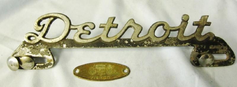 Two vintage auto emblems - detroit - body by fisher