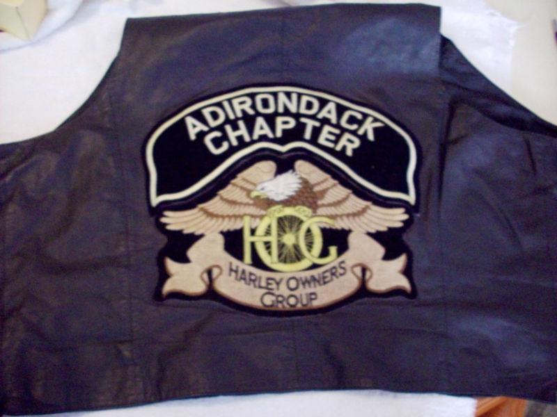 "vintage harley davidson leather vest with thirty-one badges"