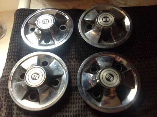 Rare triumph gt6 hub caps. set of 4 used with all springs but 1.