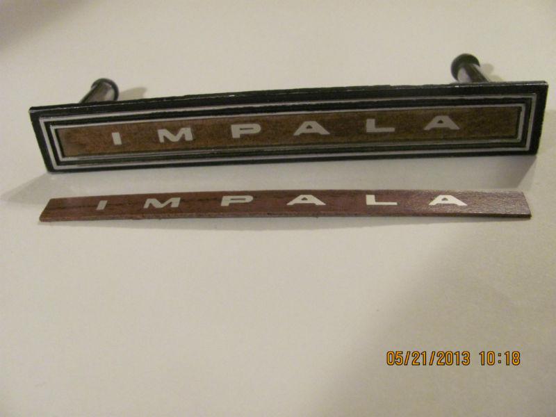 1966 chevy impala->rare "nos" gm woodgrain insert w/"impala" for dash emblem 