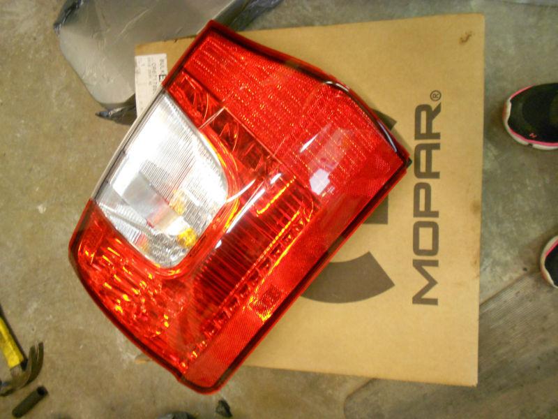 Chrsysler town and country oem drivers tail light 