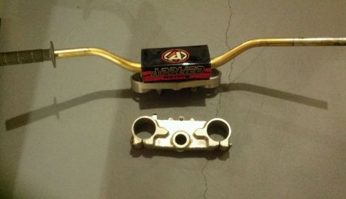 Applied racing upper and lower triple clamps &amp; pro taper bars.