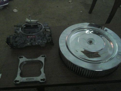 Edelbrock 1406 carburetor with spacer.