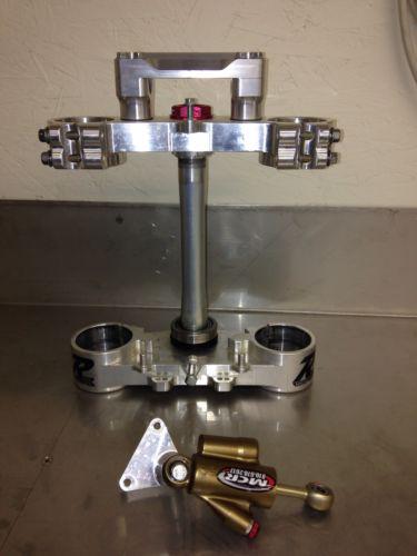 Ride engineering yamaha yzf450 triple clamps with honda steering stabilizer.