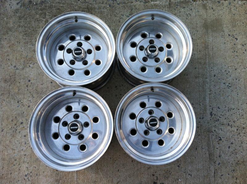 Prime 15" x 8 1/2" polished wheels w/ center caps 5 on 4 3/4" lug pattern gm