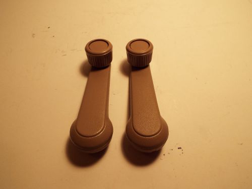 Tan ford escort interior window crank handles.