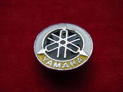 A vintage enamel motorcycle pin badge: "yamaha"