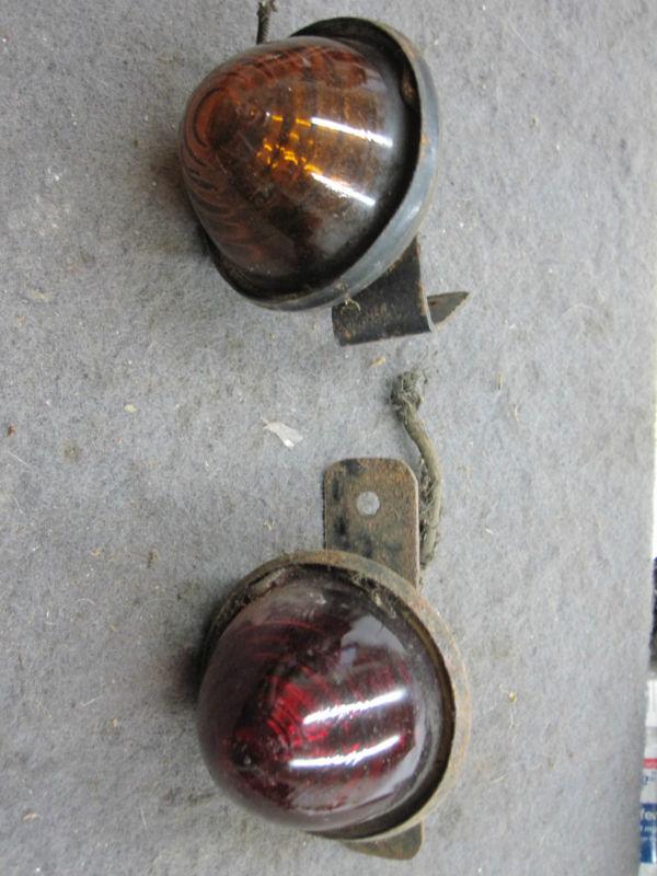 Pair of small glass lights, one red, one amber, sae-t-ray on the amber , antique