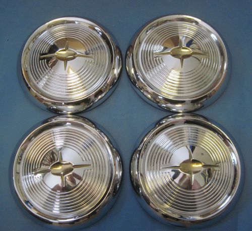 New old stock set of 4 1957 oldsmobile hub caps dog dish type