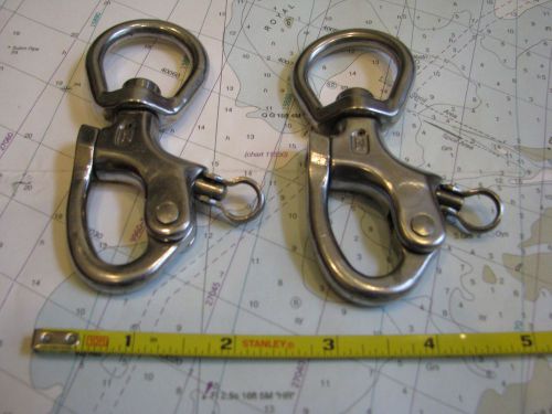 A pair of stainless steel snap shackles