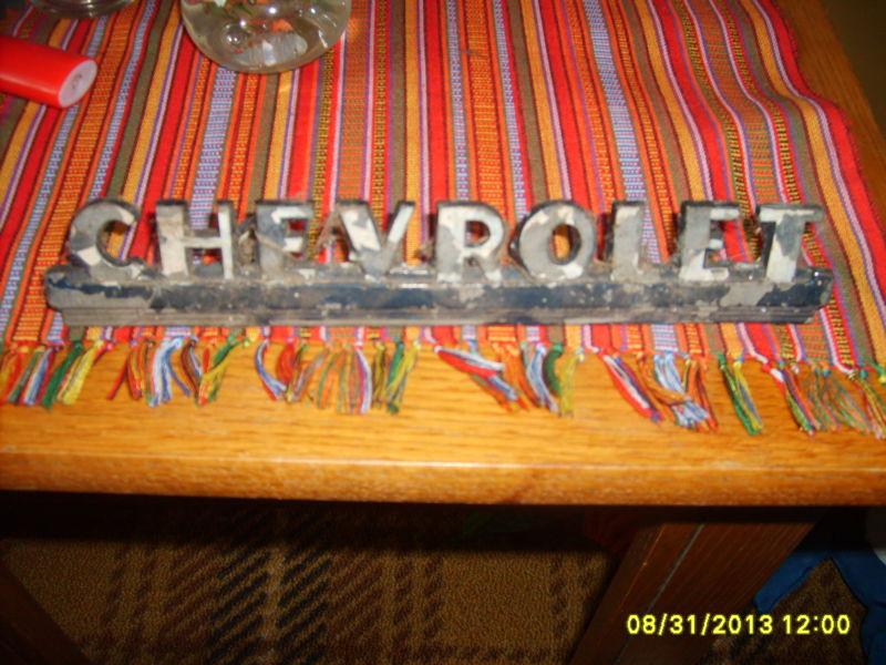 1950's  chevrolet truck emblem, metal with mounts chevy